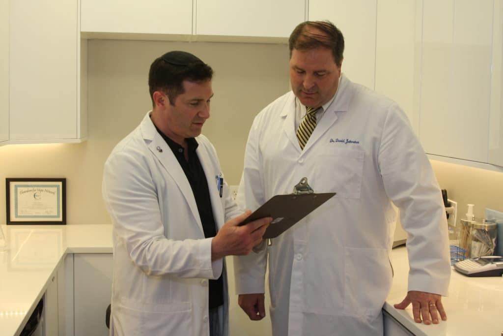 Dr Adam Breiner and Dr David Johnston reviewing patient chart